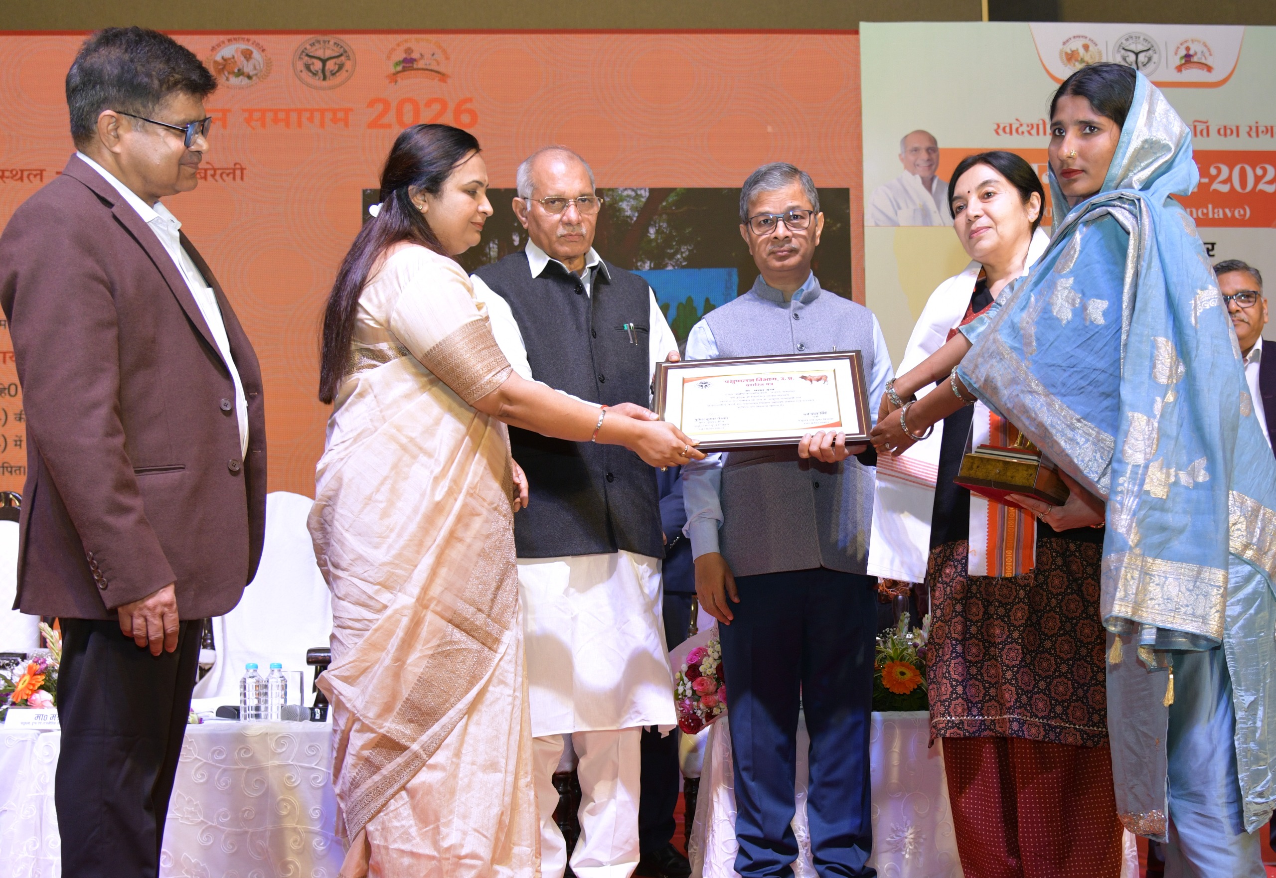 कार्यक्रम में दुग्ध उत्पादकों को पुरस्कृत करते मंत्री