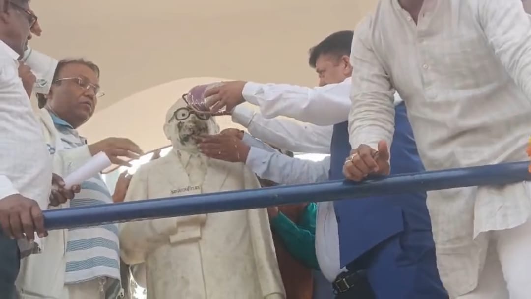 कालिख लगी अम्बेडकर प्रतिमा को साफ करते हुए जिलाधिकारी डॉ दिनेश चंद्र सिंह