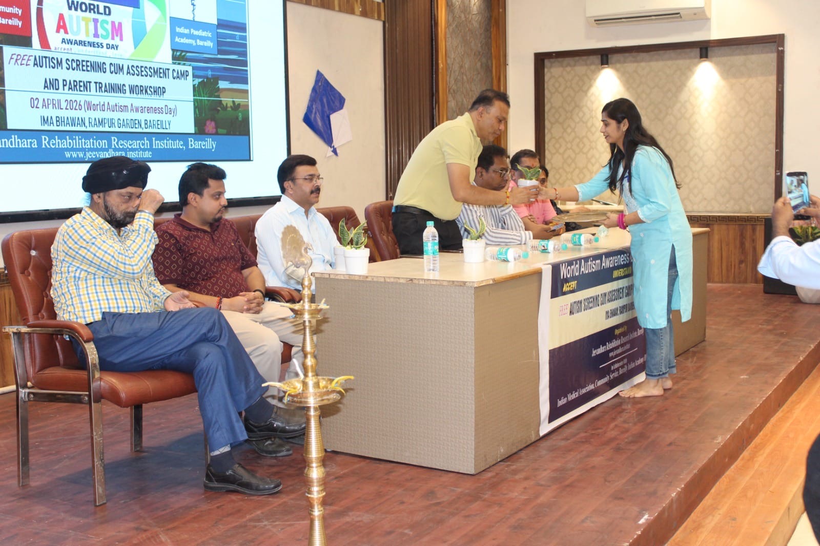 बरेली में विश्व ऑटिज्म जागरूकता दिवस पर आयोजित कार्यक्रम में दीप प्रज्ज्वलित करते अतिथि और मौजूद अभिभावक।